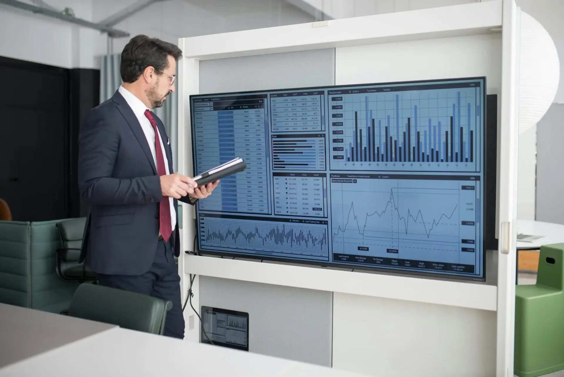 Financial consultant analyzing data and charts on a digital screen